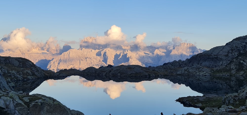 a mountain range with a lake surrounded by rocks