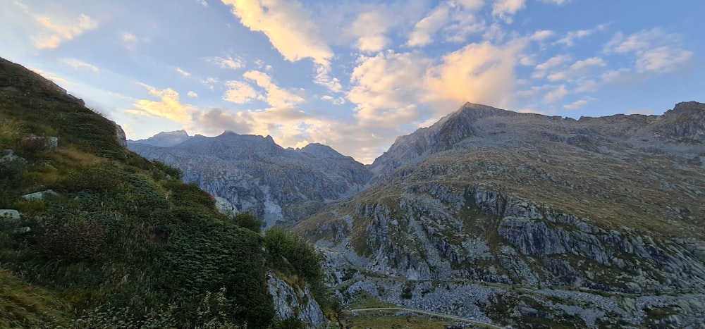 a scenic view of a mountain range with clouds in the sky