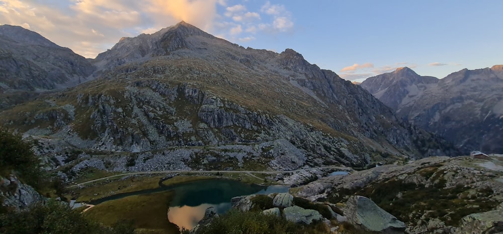 a view of a mountain range with a lake in the foreground