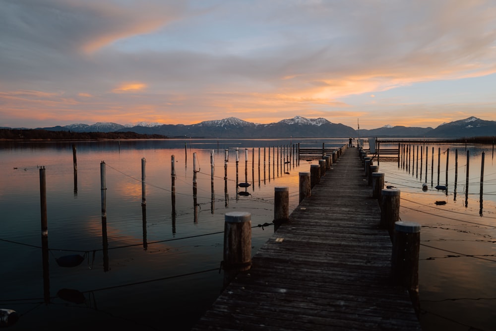 a long dock with a mountain range in the background