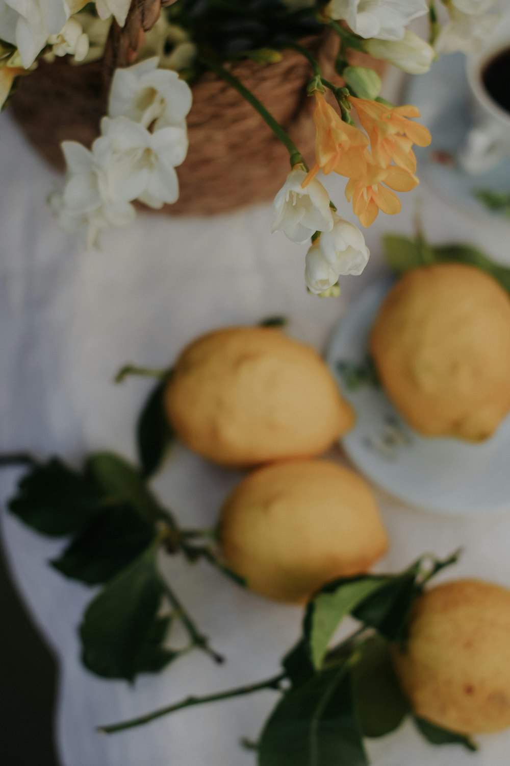 a table topped with lemons and a cup of coffee