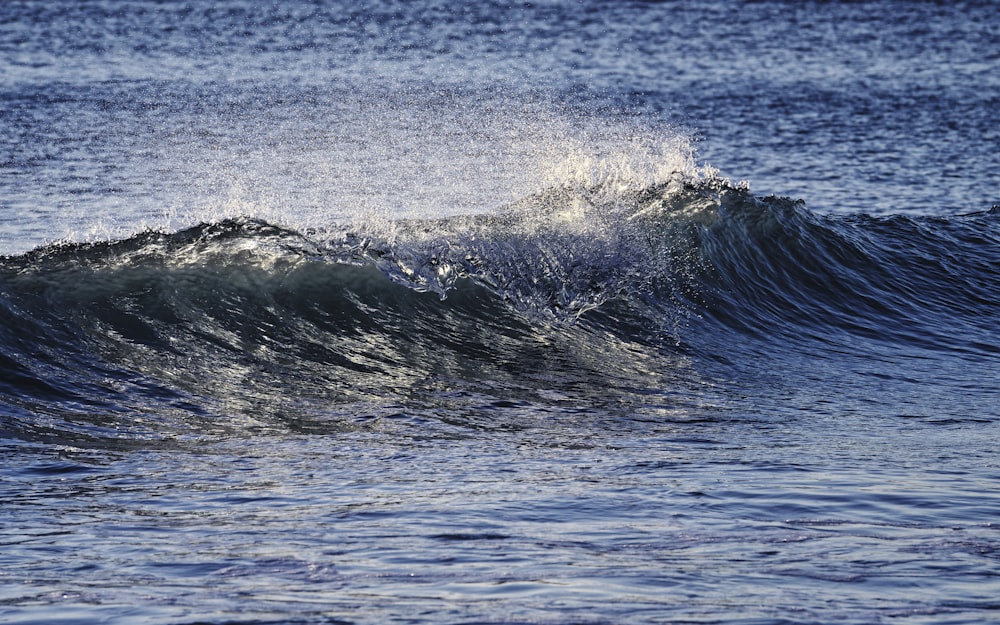 a person riding a wave on top of a surfboard