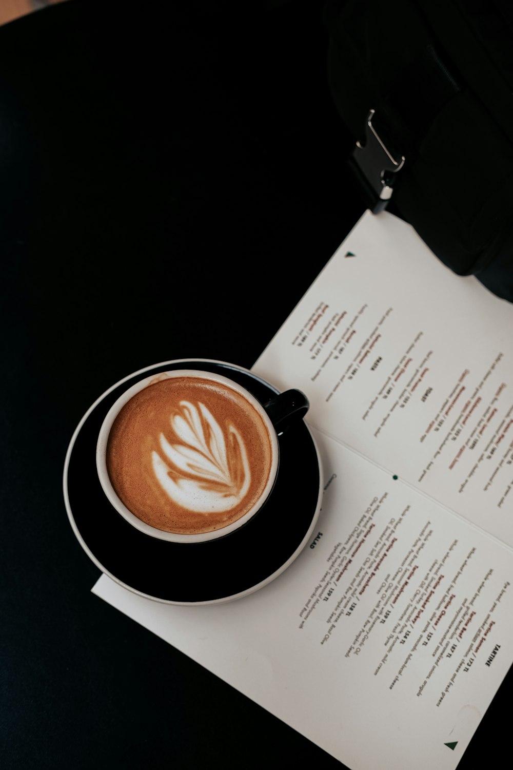 a cup of coffee sitting on top of a table