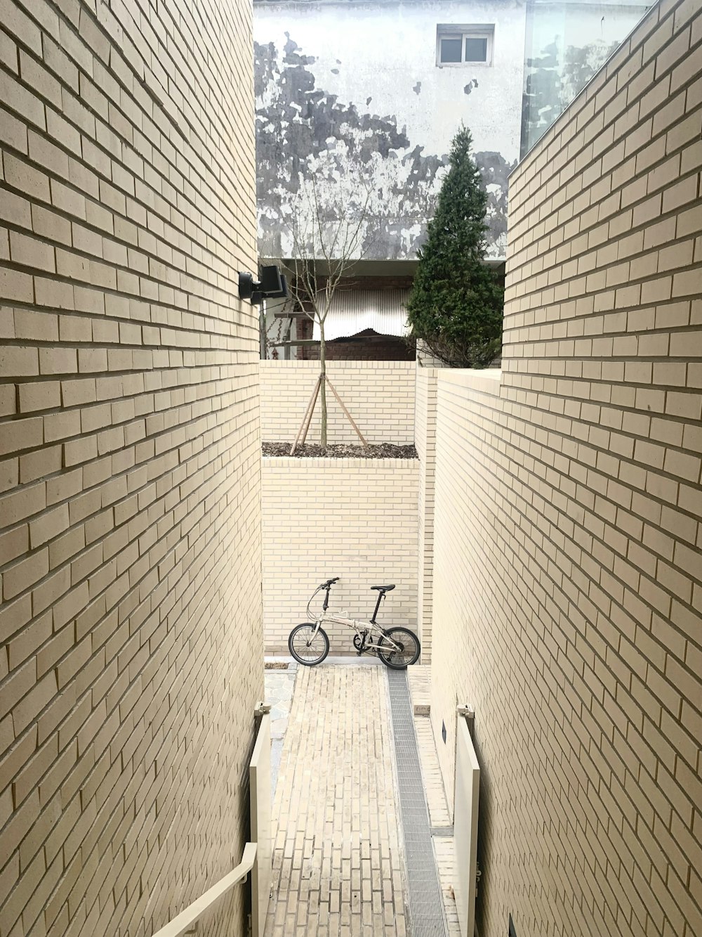 a bicycle is parked in a narrow alley