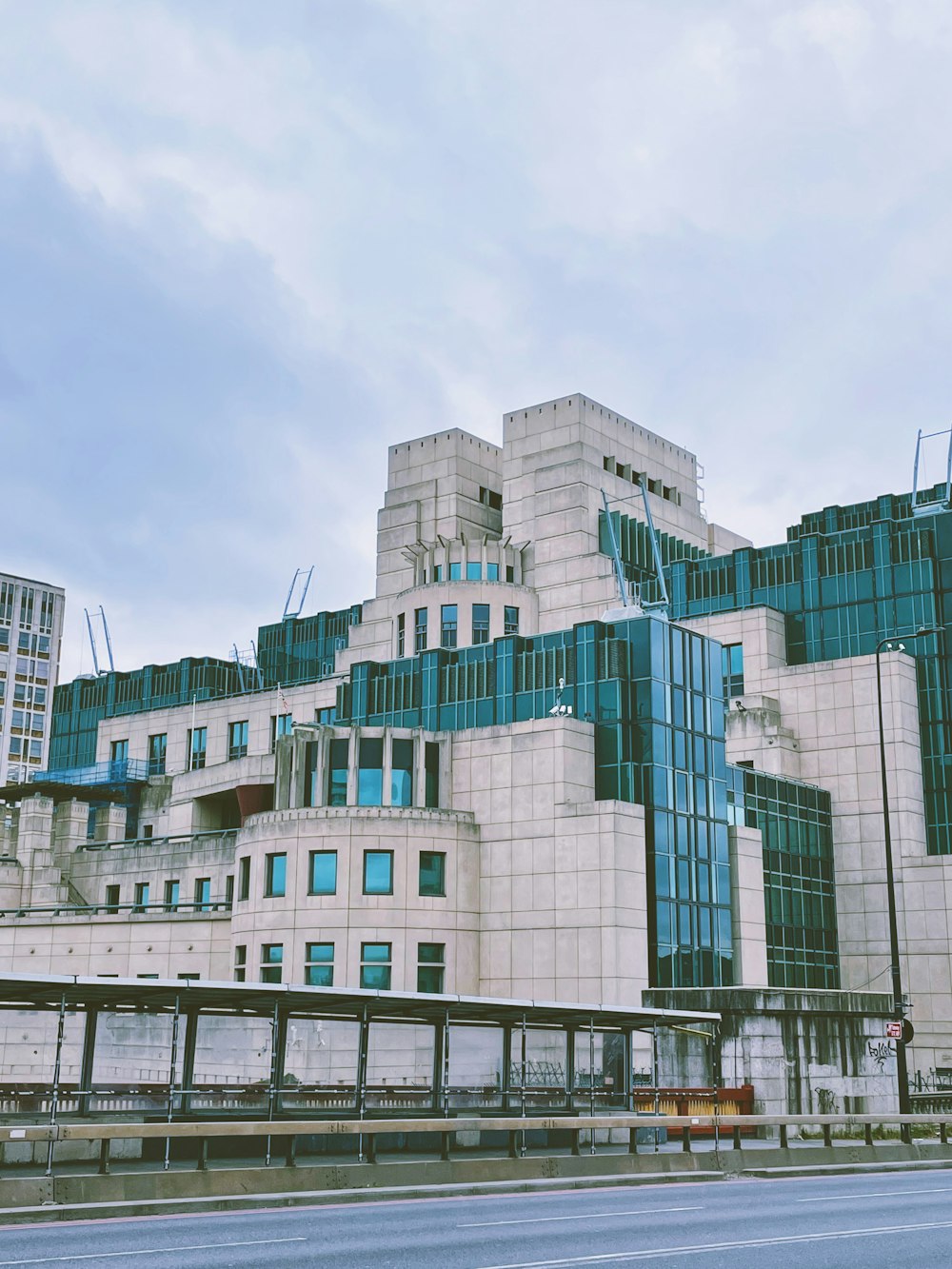 a large white building with blue windows on a cloudy day