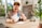 Smiling woman receiving a home cleaning service in a bright living room.