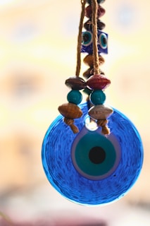 a blue bird feeder hanging from a rope