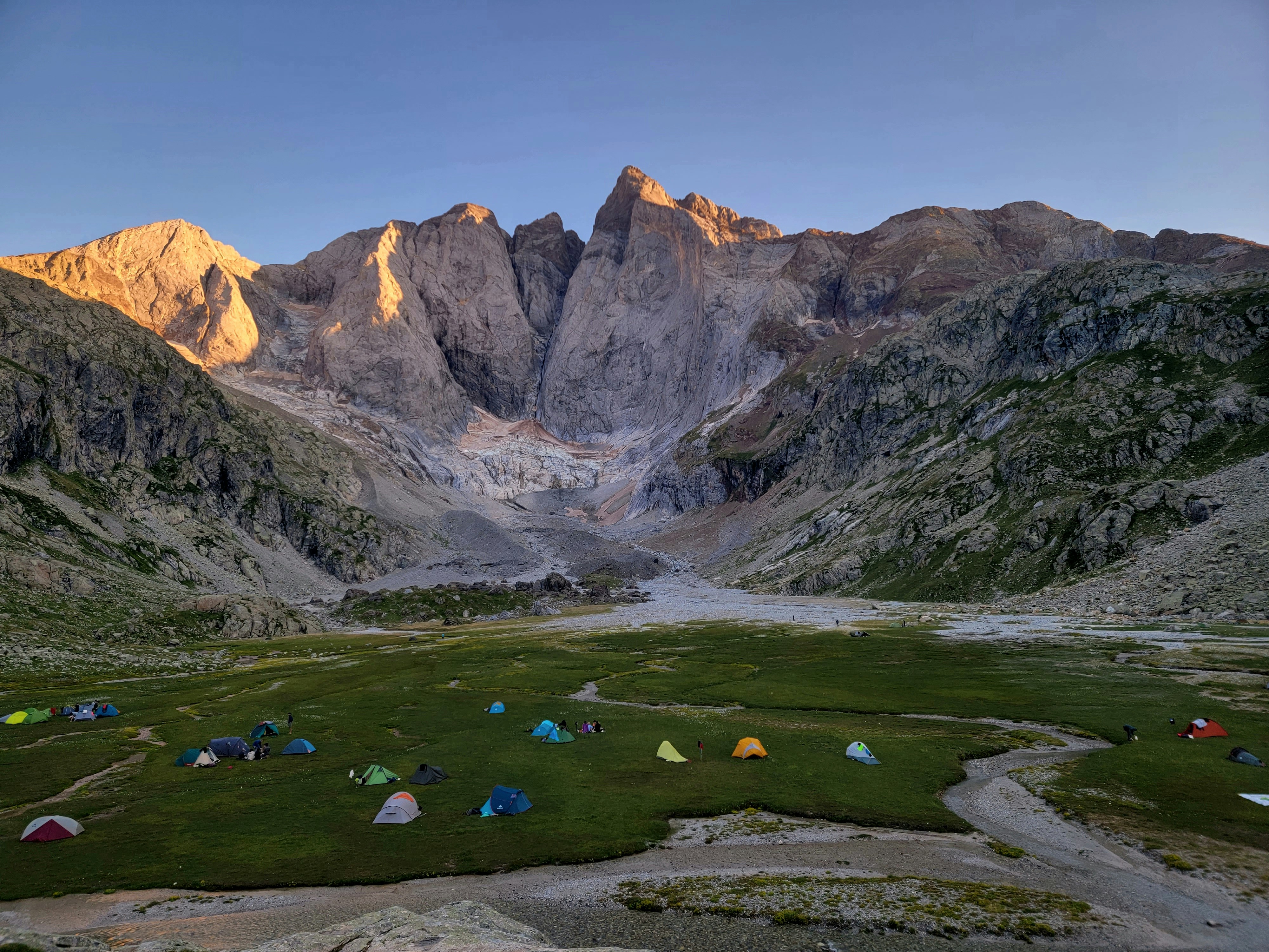 a group of tents set up in the mountains, View at Vignemale, Parc national des Pyrénées: Hiking, climbing & skiing in a vast scenic mountain region with wildlife & peaks up to 3,298m. Refuge des Oulettes de Gaube