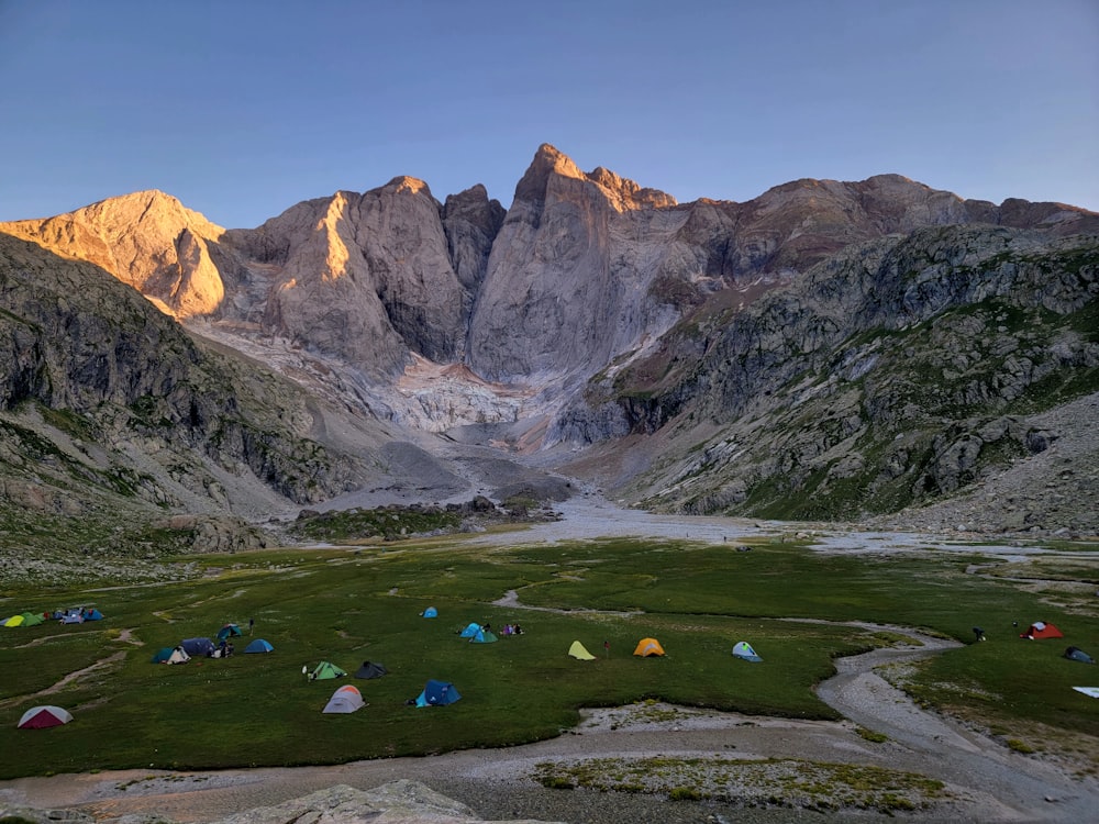 a group of tents set up in the mountains