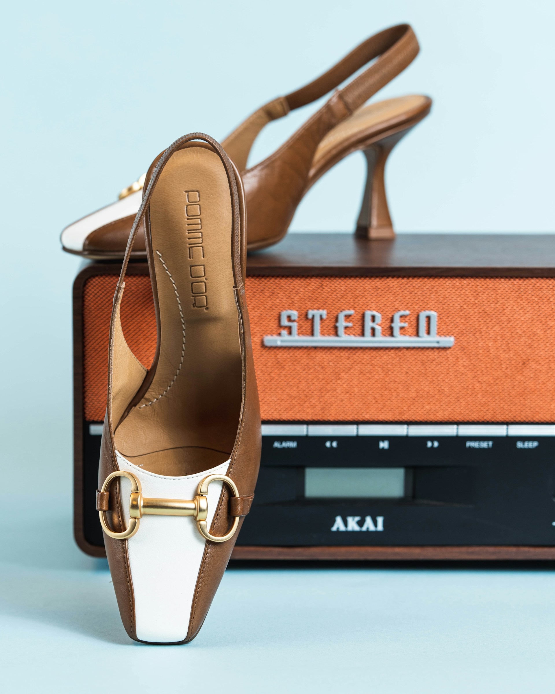 a pair of shoes sitting on top of a radio