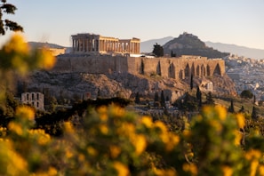 Ancient ruins on a hillside bathed in warm morning light