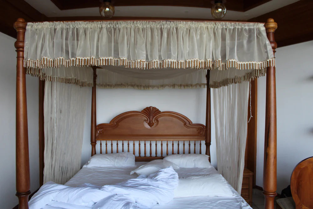 Family room with a large carved four-poster bed