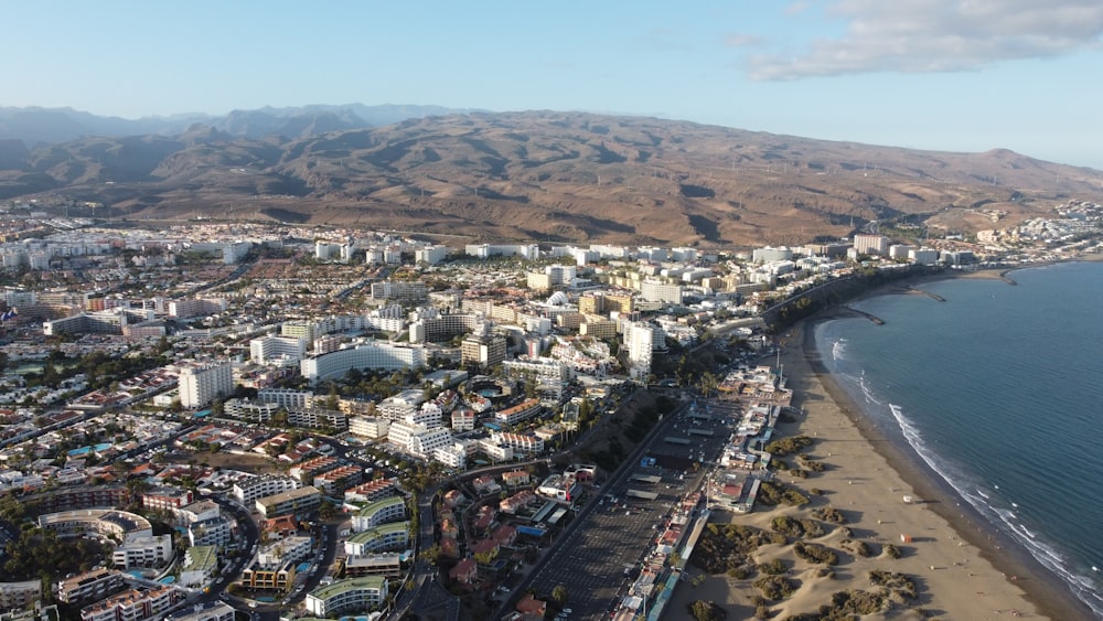 an aerial view of a city next to the ocean