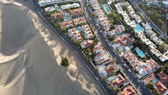 an aerial view of a city with sand dunes