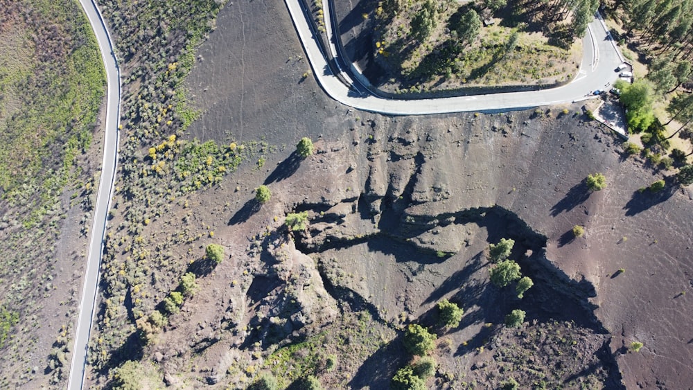 an aerial view of a winding road in the mountains