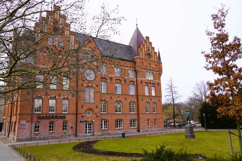 a large red brick building with a clock tower