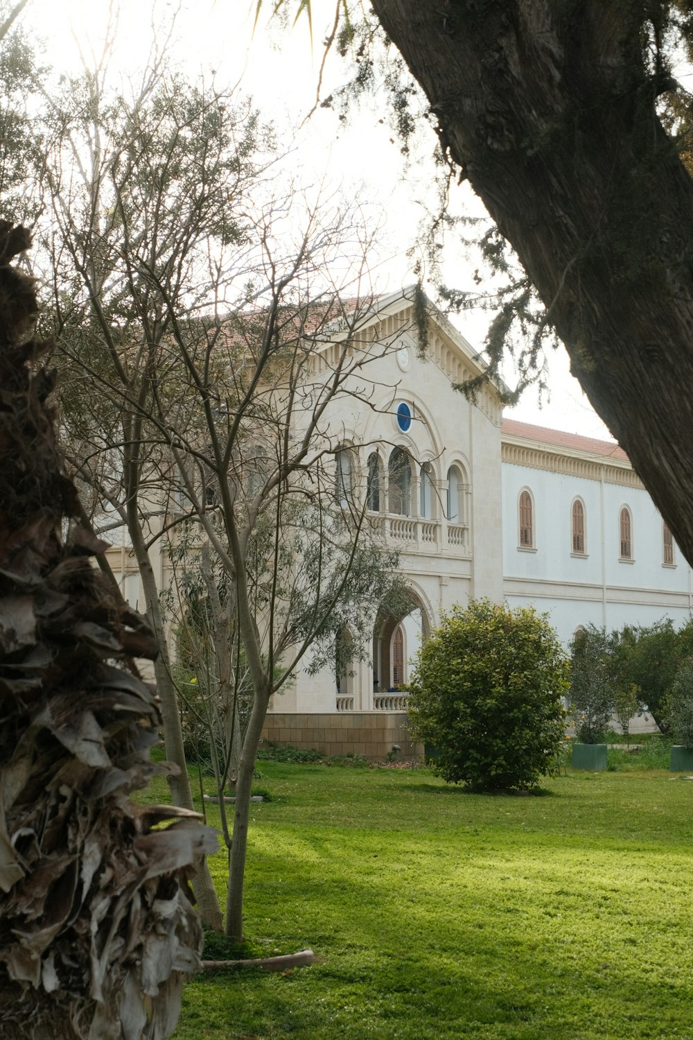 a large white building with a clock on the front of it