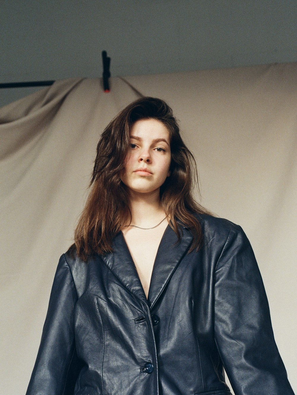 a woman in a leather jacket posing for a picture