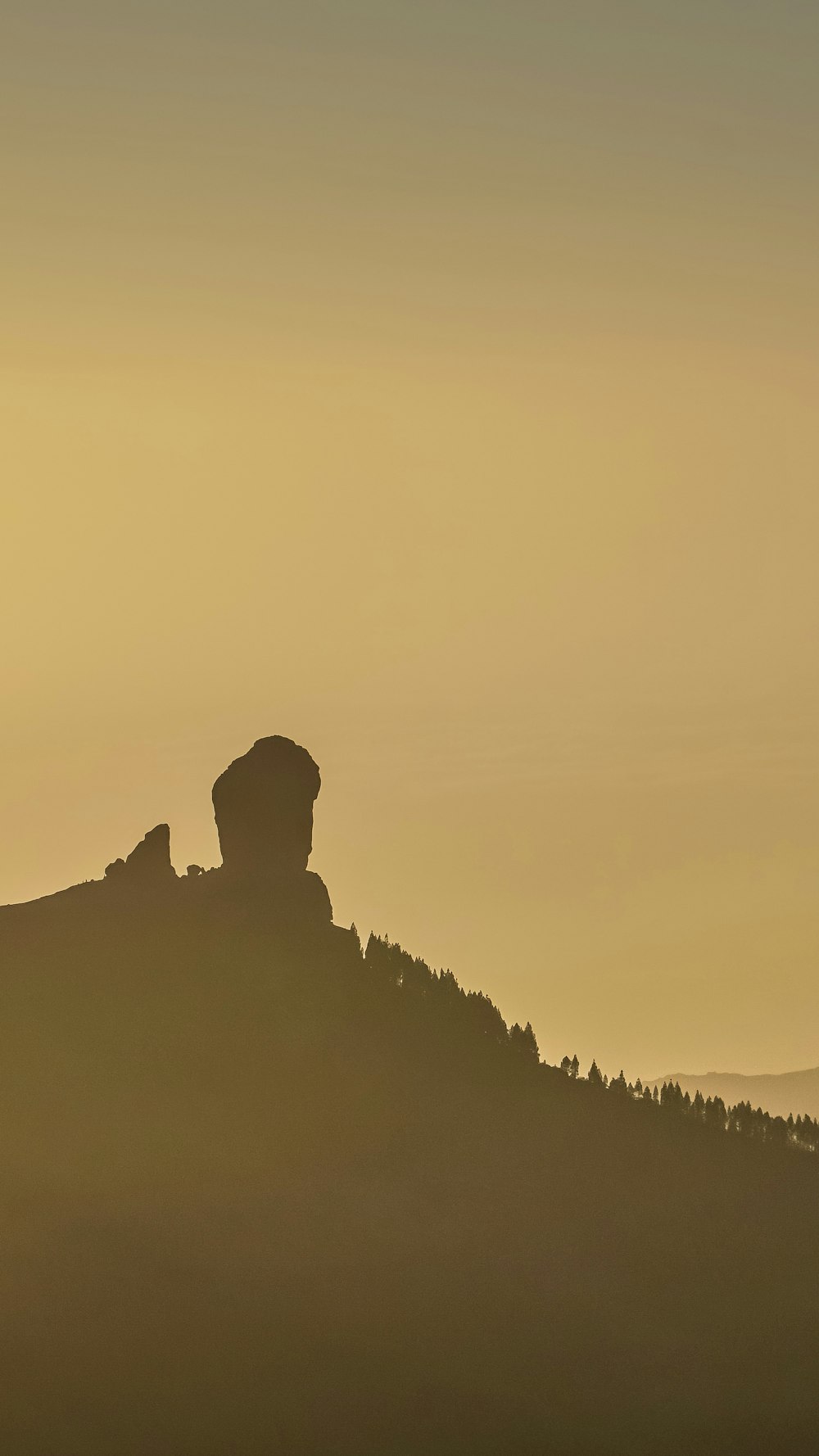 a hill with a large rock formation on top of it