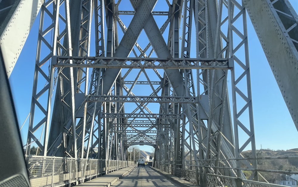 a train traveling over a bridge on a sunny day