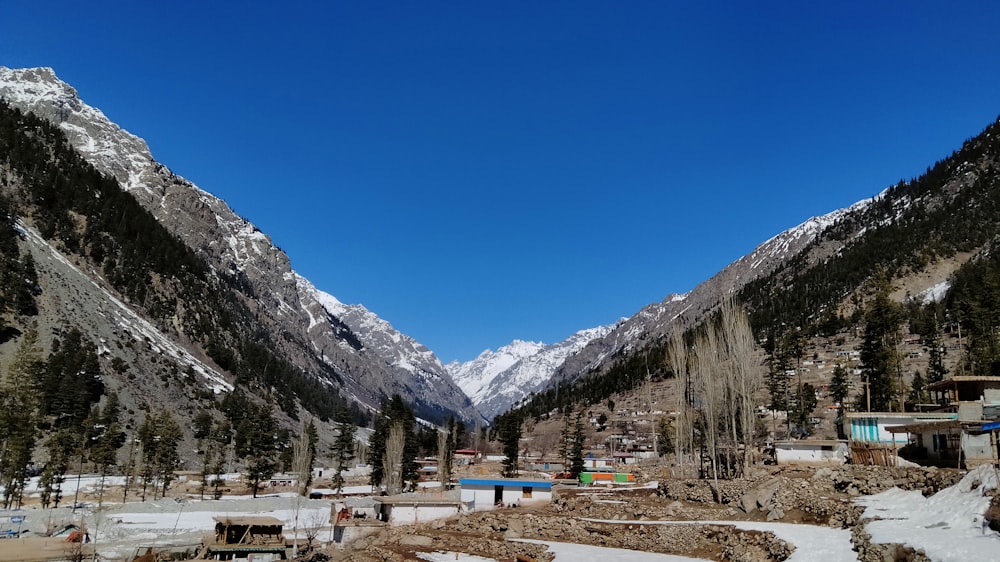 a view of a mountain range with snow on the ground