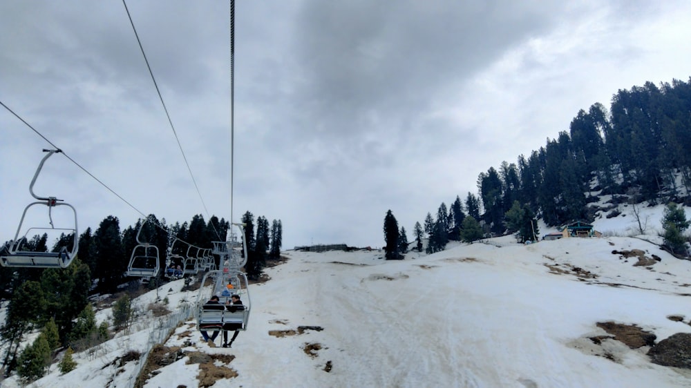 a ski lift going up a snowy mountain