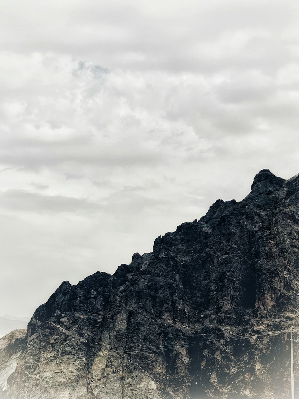 a boat is in the water near a mountain