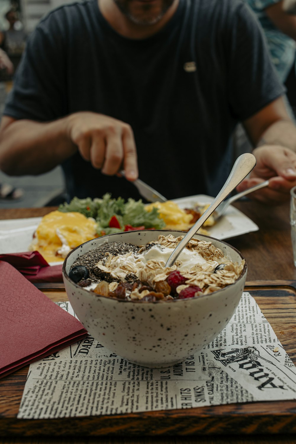 a man eating a bowl of cereal with a spoon