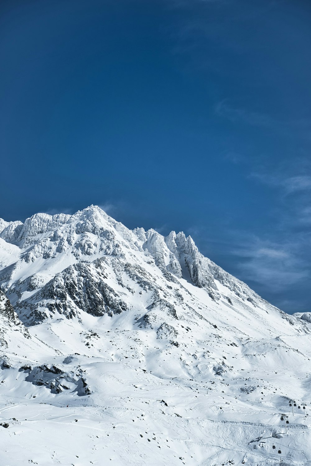 a mountain covered in snow under a blue sky