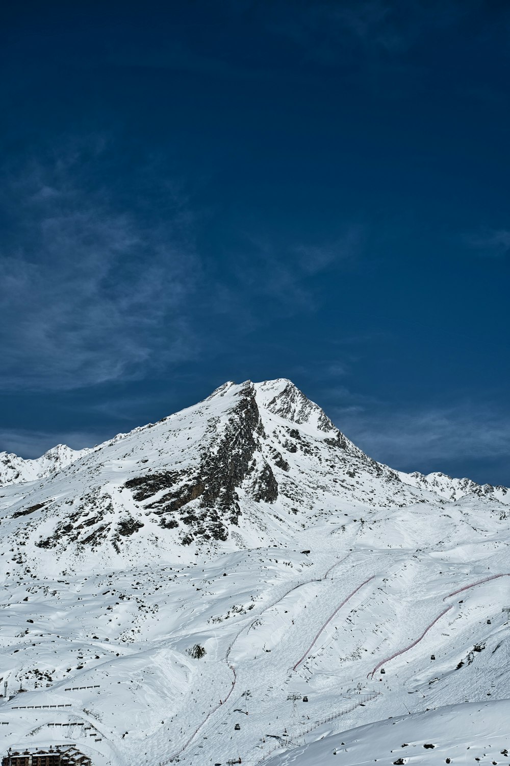 a mountain covered in snow under a blue sky