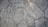 A textured surface composed of irregularly shaped stone tiles, each tile defined by distinct edges and a slightly weathered appearance. The stones vary in size and pattern, showing subtle variations in color and surface detail.