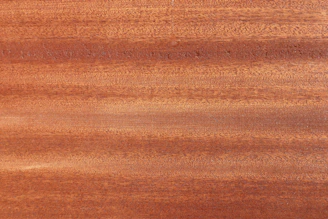 Warm walnut wood texture blending into a white background with subtle animations.