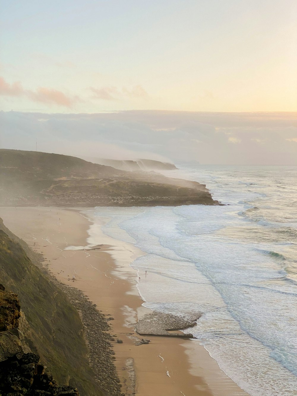 a view of a beach from a cliff