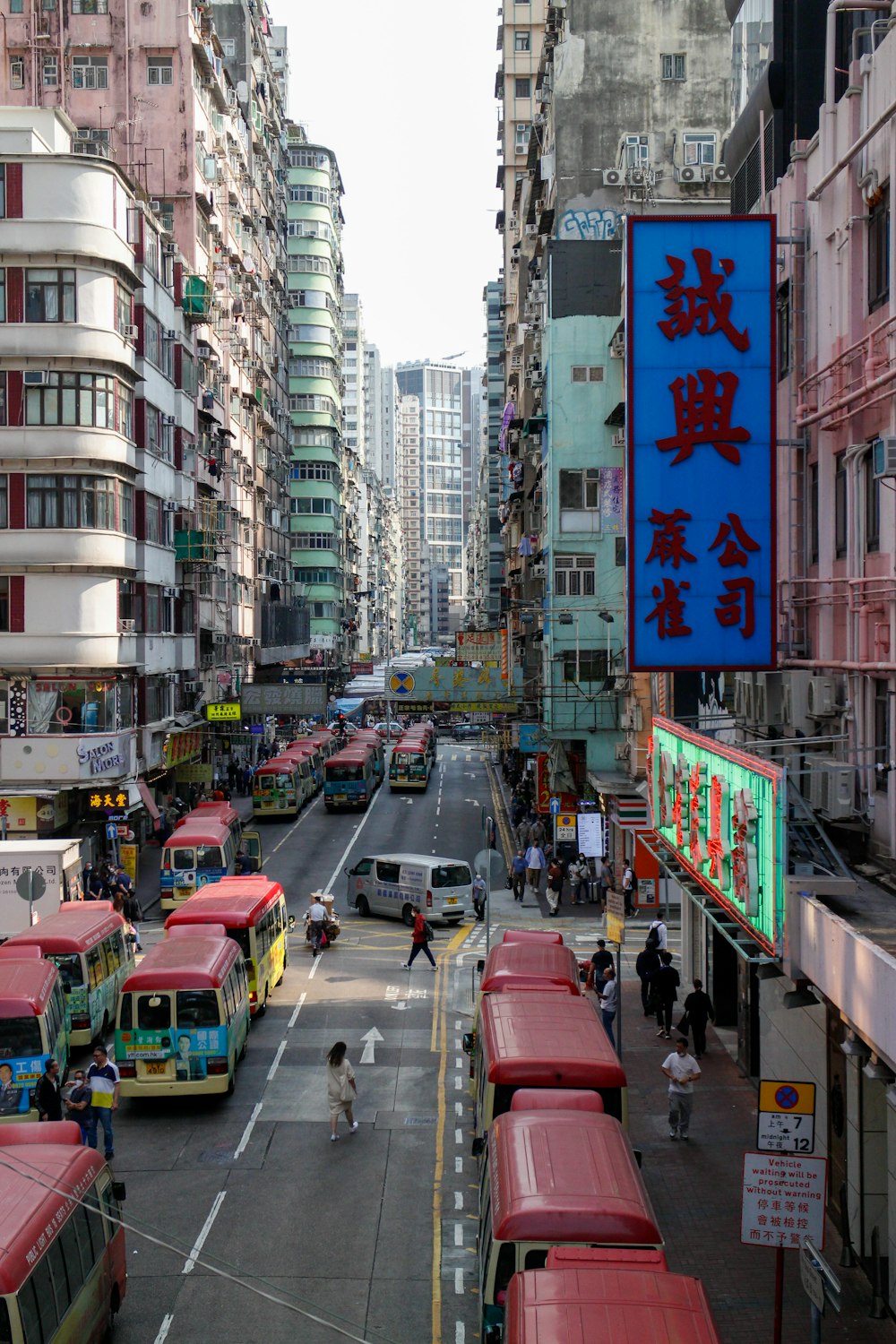 a city street filled with lots of traffic and tall buildings