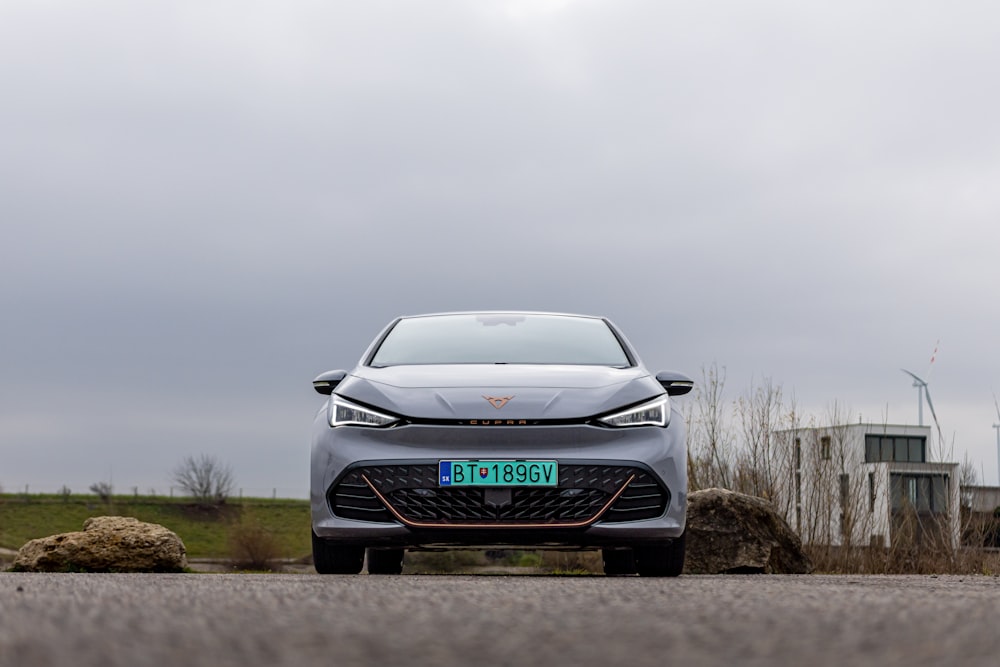 a grey car parked on the side of a road