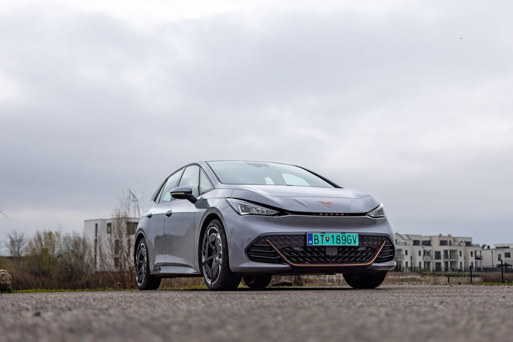 a silver car parked on the side of a road