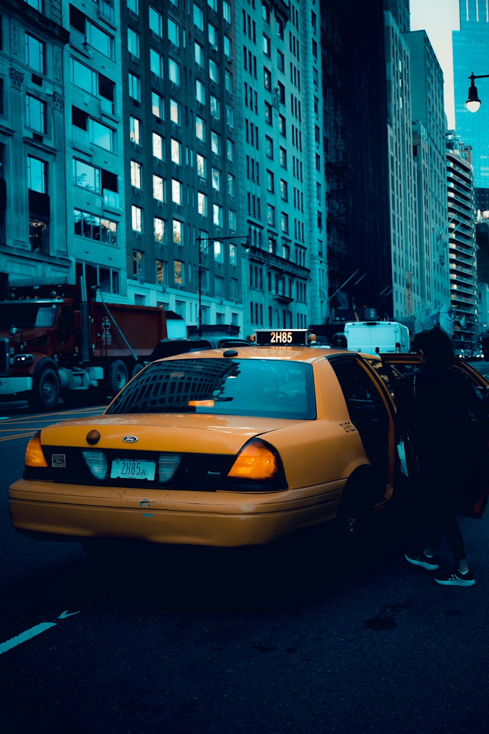 a taxi cab with its door open on a city street