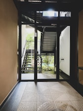 an open door leading to a stairway leading to a balcony