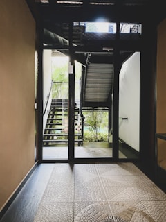 an open door leading to a stairway leading to a balcony