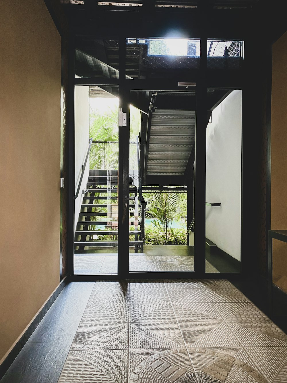 an open door leading to a stairway leading to a balcony