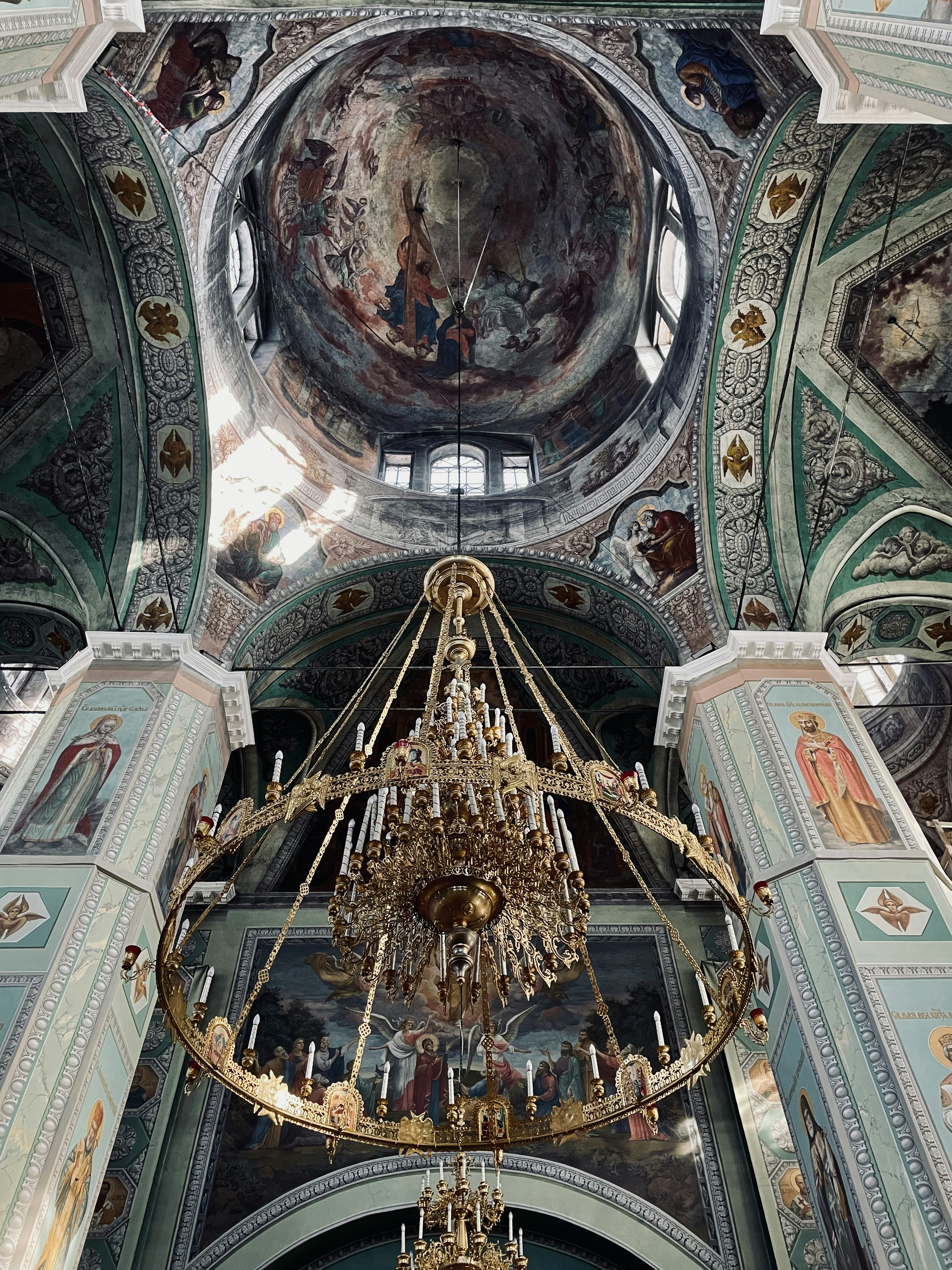 a chandelier hanging from the ceiling of a church