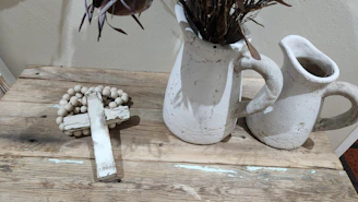 A collection of Staurolite crosses displayed on a rustic wooden table with Native American patterns.