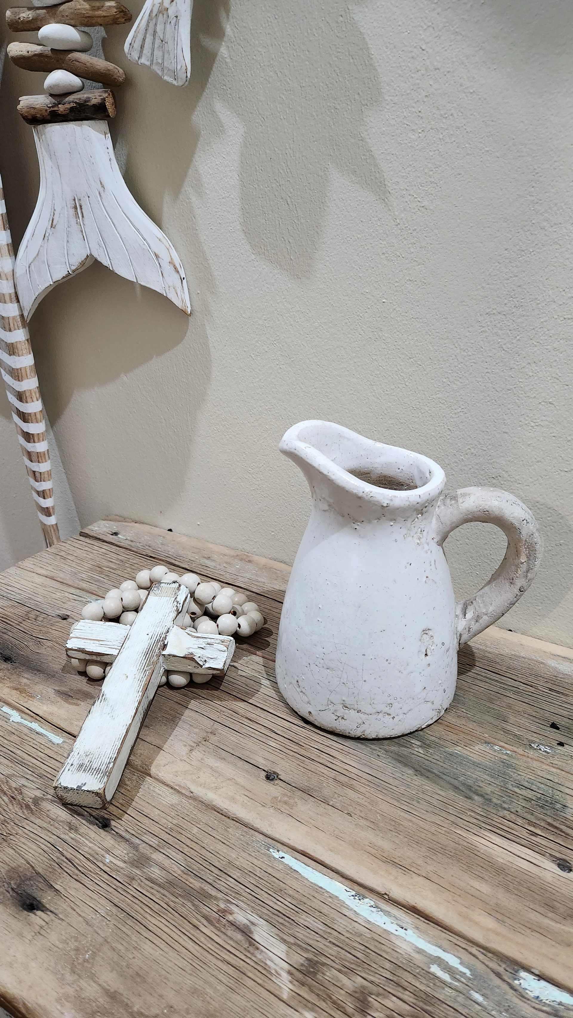 A vibrant display of colorful Christian-themed gifts and accessories arranged on a rustic wooden table.