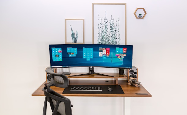 a computer monitor sitting on top of a wooden desk