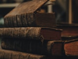 A stack of well-preserved books with worn covers, inviting to be read.