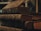 A stack of old, worn books with dark, textured covers and faded red page edges, conveying a sense of antiquity and history.