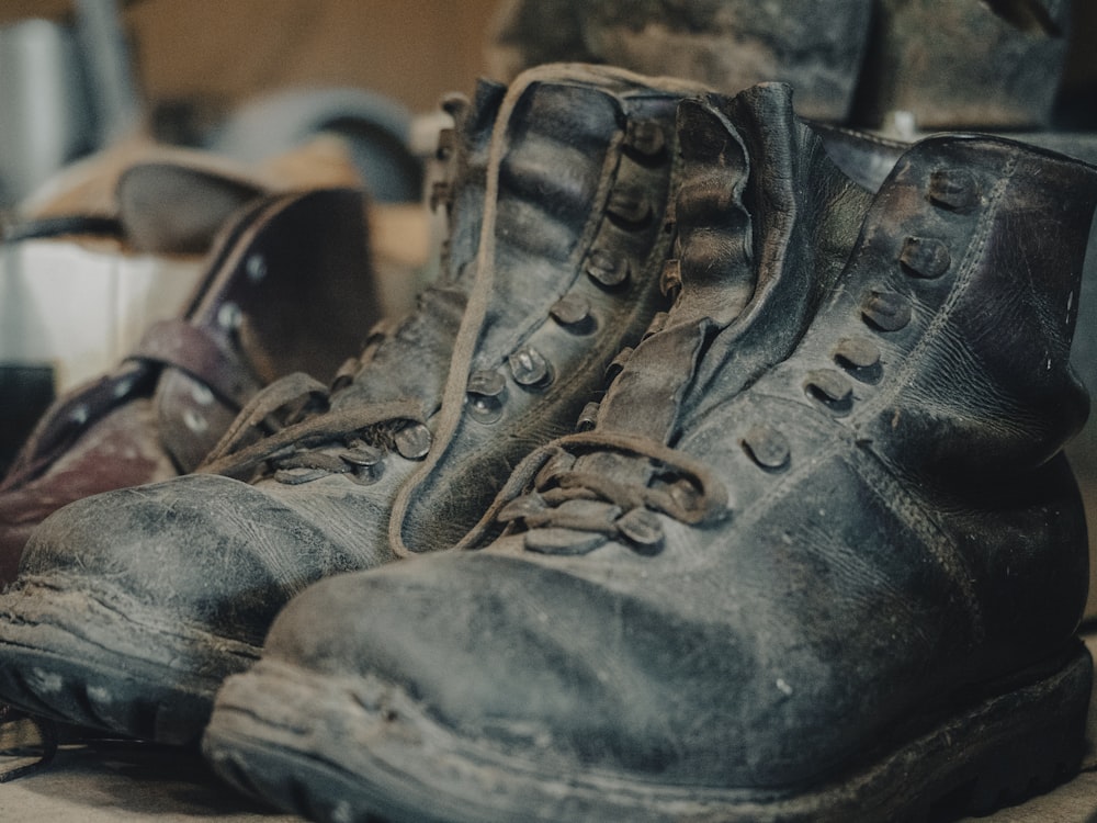 a pair of dirty boots sitting on top of a table