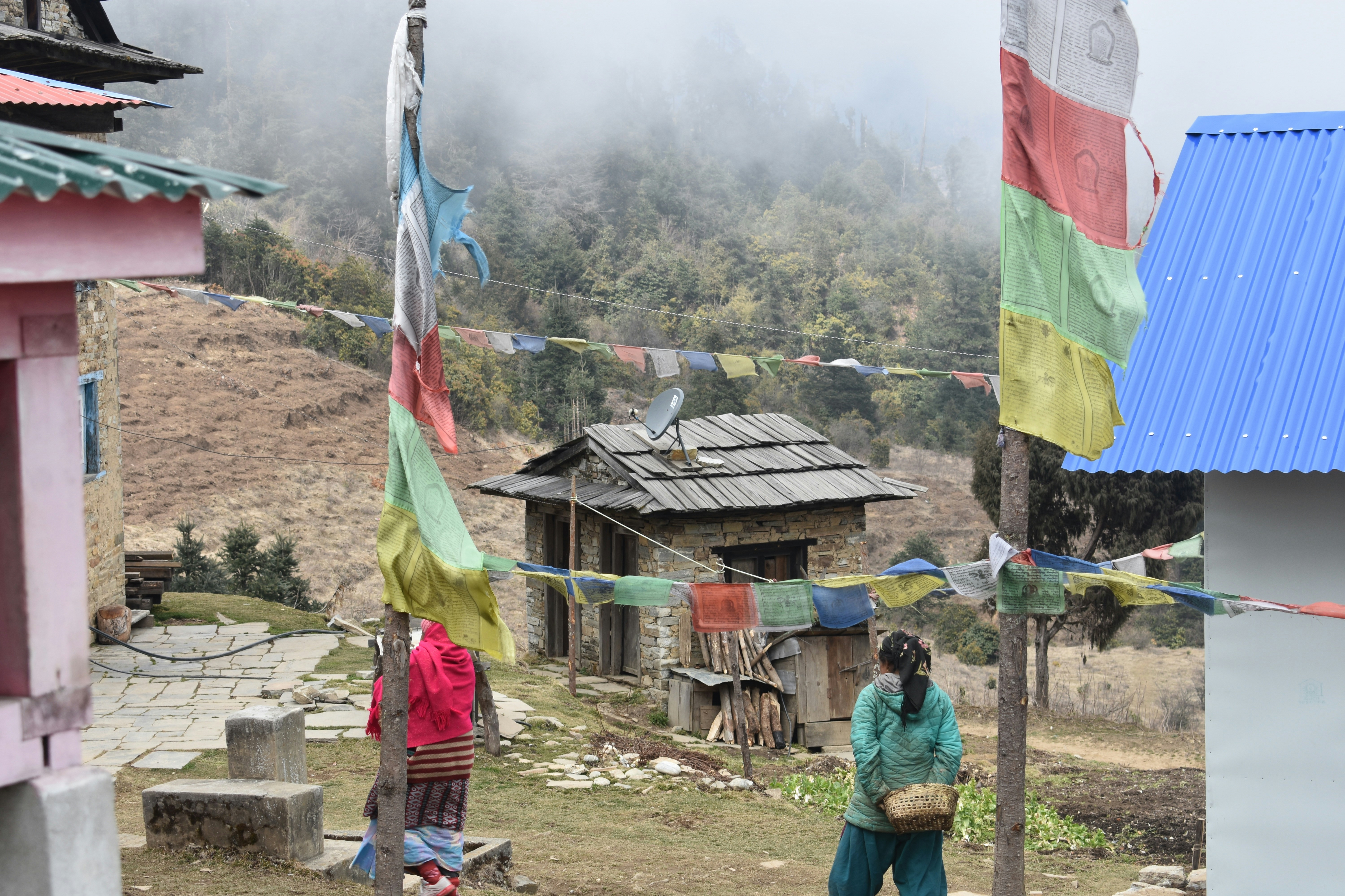 Prayer flags and village in the Himalayan Mountains.