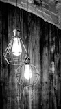 Industrial cage pendant lights hanging over a rustic kitchen island, blending style and function.
