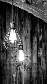 An industrial retro pendant light hanging over a rustic wooden table.